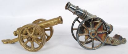 Two desktop cannons, one being brass