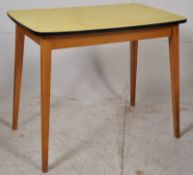 A 1950's retro yellow and beech wood formica kitchen table. Tapered angular legs with yellow formica