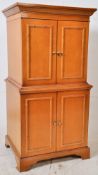 A large beech wood bamboo effect cabinet. Raised on plinth base with drawers under cabinet atop