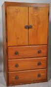 A 1930's Art Deco beech wood  tallboy chest of drawers.The twin door cupboards over drawers.