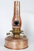 A Victorian copper oil lamp with unusual copper chimney having lighting hole to side. The copper