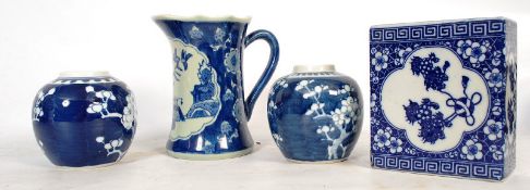 A blue and white Chinese oriental pillow, along with a pair of china ginger jars and a jug.