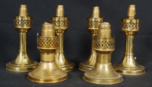 4 brass Mason constant flame candlesticks. 2 pairs, one set large, the other small, all stamped to