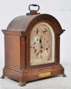 A 1920's oak cased bracket clock, the arched case with single glazed door, silvered dial having
