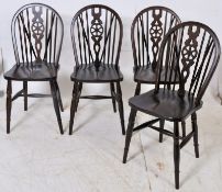 A set of 4 beech wood wheelback dining chairs. Turned legs united by stretchers having saddle