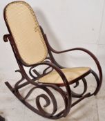 A Thonet style 20th century caned rocking chair. Sleigh runner with caned seat and backrest and