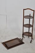 A 1930's oak metamorphic cake stand along with 2 butlers / serving trays. 86cm tall.