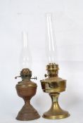 2 Victorian oil lamps complete with glass chimneys. One being brass, the other copper