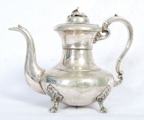 A Victorian silver plate teapot, with engraved unicorn emblem to front. Standing on claw feet with