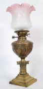 A Victorian Art Nouveau brass oil lamp. The square terraced base of stepped form having a decorative