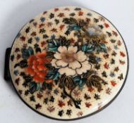 A Japanese Satsuma buckle of circular form having central spray of flowers.