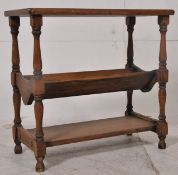 An 18th century style oak book trough side table. Raised on block and turned  legs united by a