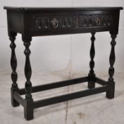 A Jacobean revival oak hall table. The turned legs united by stretchers having single linen fold