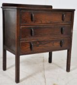 A 1930's small oak chest of drawers. Raised on square legs having a series of drawers above.
