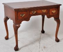 A Georgian style mahogany inlaid writing table desk in the Queen Anne revival style. The large
