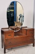 A 1930's Art Deco oak dressing table chest of drawers. Raised on rocket style atomic feet having a