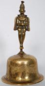 A decorative cast bronze bell with monkey atop and decorative animal decoration to bell.