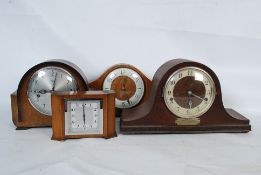 A collection of early 20th century clocks to include an Art deco example, napoleons hat and others