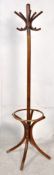 A Thonet style bentwood hatstand. The shaped legs with central pillar having bentwood hooks atop