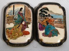A Japanese belt buckle with exquisite paintings of oriental figures with coloured backgrounds.
