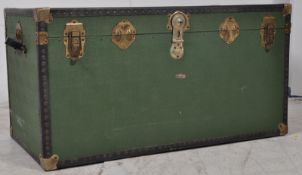 A 20th century 1950's canvas and metal bound trunk chest. The green panelled body with makers name