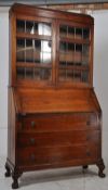 A 1930's Art Deco solid oak bureau bookcase cabinet. Cabriole legs with ball and claw feet