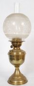 A Victorian brass oil lamp. The circular terraced base of stepped form having a bulbous central