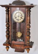 A Late Victorian walnut cased Vienna style wall clock, the case surmounted with bell over glazed