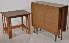 A retro Danish style teak wood nest of tables. Together with a drop leaf formica faux teak dining