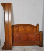 A 20th century Fruitwood french double bed. The shaped head and footboard united by wooden