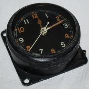 A WWII aircraft clock with rotating bezel and alloy case