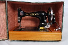 A vintage Singer sewing maching converted for electricity complete in the original faux crocodile
