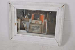 A large early 20th century shabby chic painted pine wall mirror. The large painted frame housing