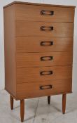 A retro 1970's formica faux teak wood upright chest of drawers. Raised on tapered legs having an