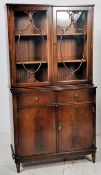 A Regency style flame mahogany library bookcase cabinet. The lower section featuring twin drawers