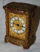 A miniature 20th century gilded carriage clock with a white enamel dial