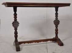 A Victorian solid mahogany side / writing table. Raised on cup and cover supports united by low