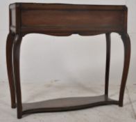 An Edwardian solid mahogany planter of French style. Raised on slender supports having a lower pan