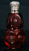 A Victorian style silver topped perfume cranberry glass bottle. Of bulbous form having a rococo