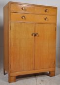 A 1930's Art Deco oak tallboy chest of drawers. Twin drawers over cupboard with hanging rail.