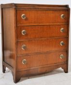A 1930's Art Deco oak chest of drawers. The upright chest having a shaped top complete with original