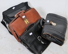 A vintage black leather attache case, a vintage brown attache case together with 2 others