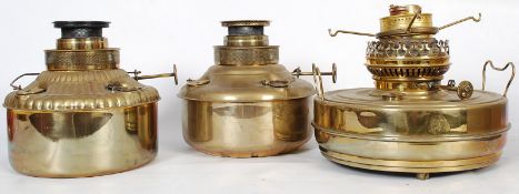 3Victorian flat bottom brass oil lamps of large form. The flat bottom reservoirs having extinguisher