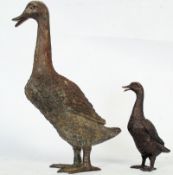 A large cast bronze figure of a duck measuring 36cms high . Together with a smaller bronze duck