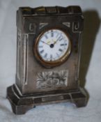 A miniature silvered carriage clock with inset Art Nouveau panel and enamel dial.