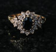 A ladies 9ct gold sapphire and diamond ring. The centre set sapphire having an oval diamond