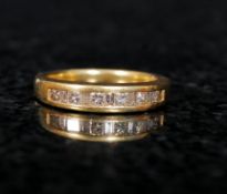 An 18ct gold ladies diamond channel set ring. The diamonds being set within the gold hoop. Weighs