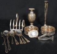 A collection of silver plate to include coasters, flatware, candlestick, toast rack, tongs, sherry