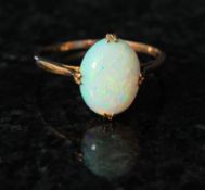 A ladies 9ct gold opal dress / cocktail ring mounted to claw on a plain gold hoop