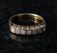 A 9ct gold ladies diamond ring. The central set diamonds mounted to a plain gold hoop